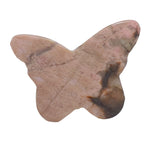 Rhodonite butterfly crystal on meditation altar with complementary healing stones
