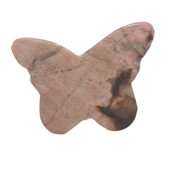 Rhodonite butterfly crystal on meditation altar with complementary healing stones