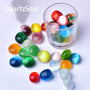 Cat's Eye polished tumbled stones collection in glass container with various sizes and colors