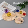 Wooden crystal ball stand with sacred geometry sun and moon phases design