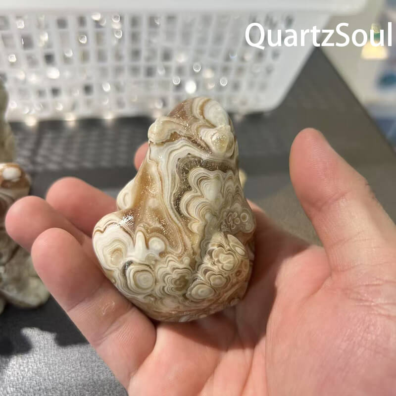 Premium wholesale chocolate calcite crystal carved into sheep shape with cream and brown swirls