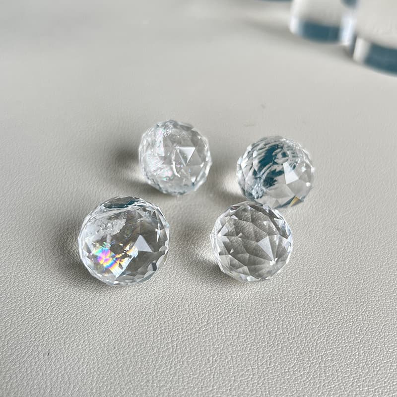 Hand-carved Clear Quartz crystal mini sphere showcasing exceptional clarity and faceted design