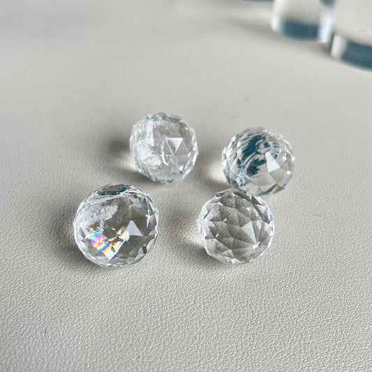Hand-carved Clear Quartz crystal mini sphere showcasing exceptional clarity and faceted design