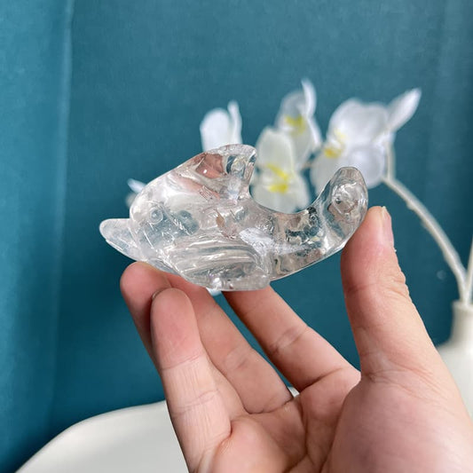 Clear quartz dolphin crystal carving showcasing transparent natural stone