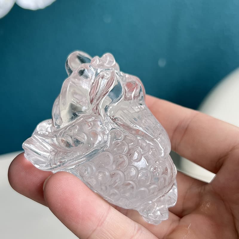 Back view of clear quartz golden toad showing carved texture details