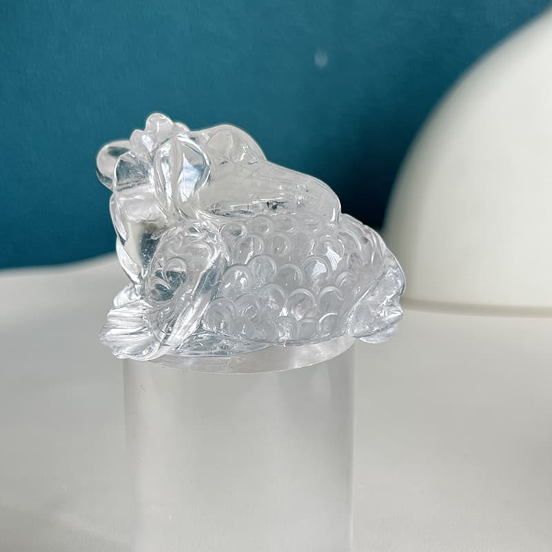 Clear quartz golden toad carving displayed as elegant home decor