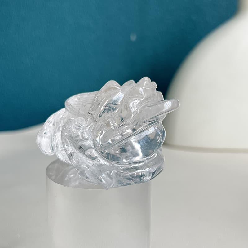 Clear quartz golden toad carving side view showing crystal clarity
