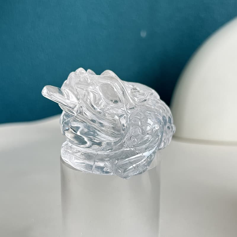 Size comparison of clear quartz golden toad carving with measurement