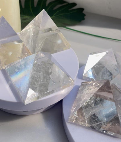 Clear quartz pyramid capturing light, ideal for crystal supply