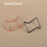 Silver and rose gold crystal display stands side by side for gemstone spheres