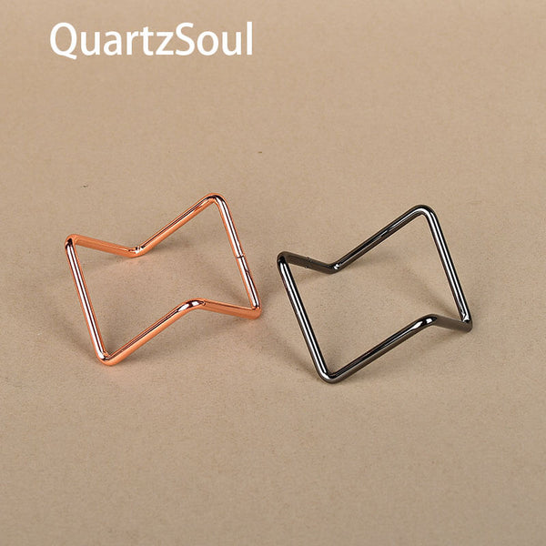 Silver and rose gold crystal display stands side by side for gemstone spheres