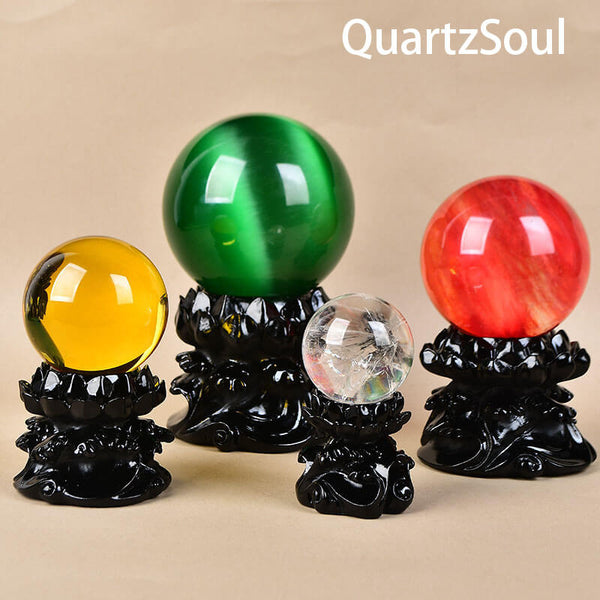 Obsidian crystal stands displaying colorful crystal spheres in various sizes