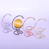 Crystal sphere display stands in gold, silver, rose gold and black with yellow sphere