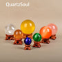 Set of wooden stands displaying colorful crystal spheres and balls