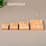 Four sizes of wooden crystal display stands with three-claw design for showcasing mineral specimens