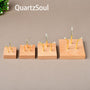 Four sizes of wooden crystal display stands with three-claw design for showcasing mineral specimens