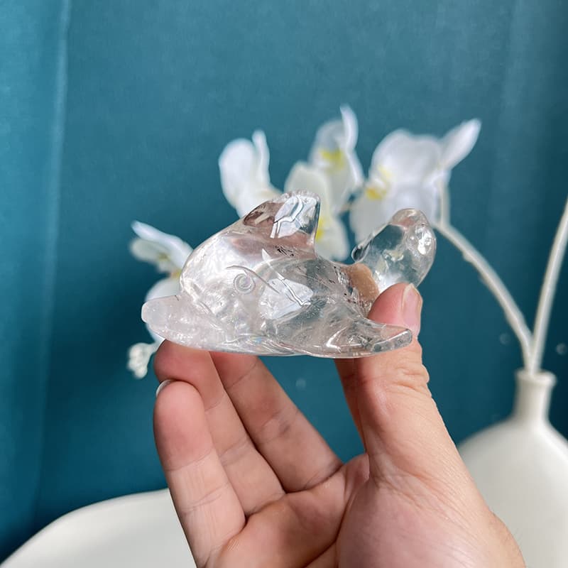 Front view of hand-carved clear quartz dolphin crystal figurine
