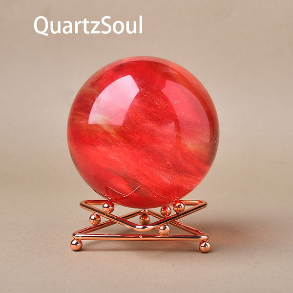 Red crystal sphere showcased on rose gold geometric display stand