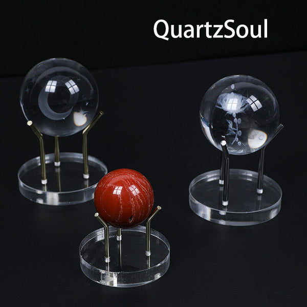 Various crystal spheres displayed on premium acrylic stands with metal prongs