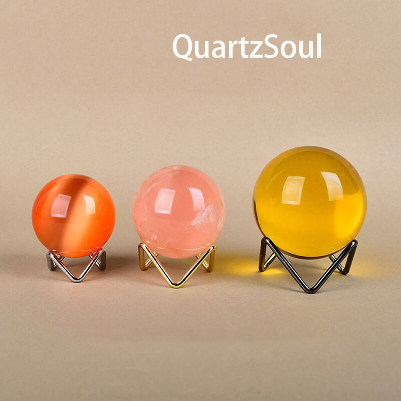 Colorful crystal spheres displayed on elegant wave stands in multiple finishes