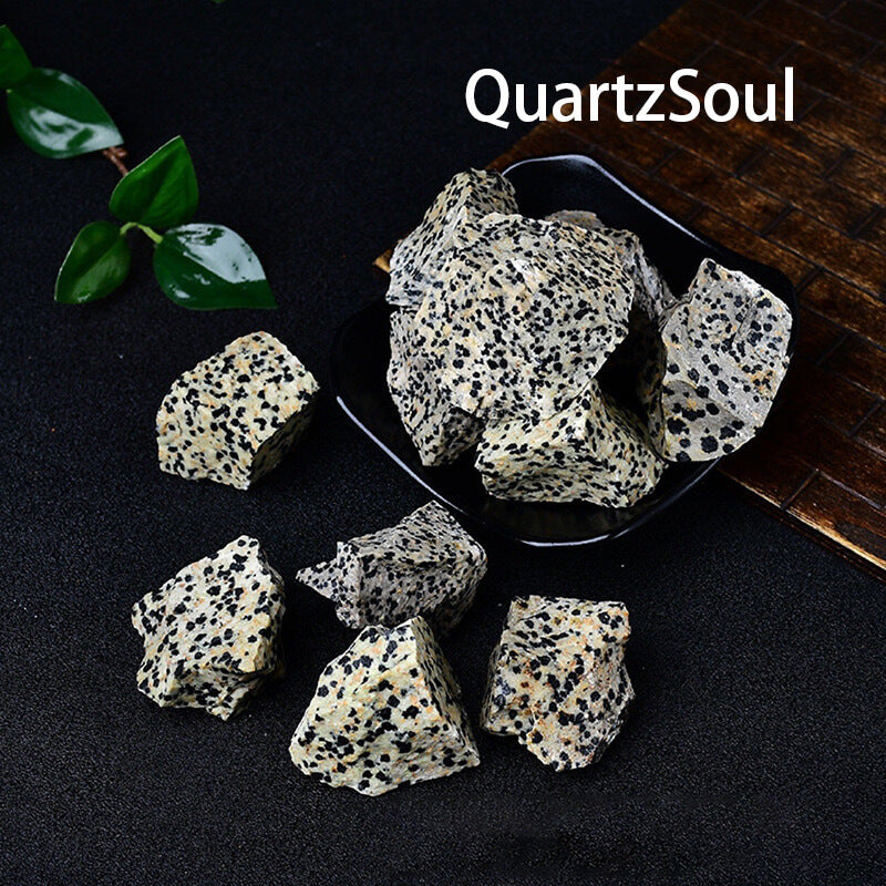 Unpolished Dalmatian Jasper crystal stones in bowl and scattered display