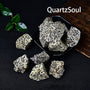 Unpolished Dalmatian Jasper crystal stones in bowl and scattered display