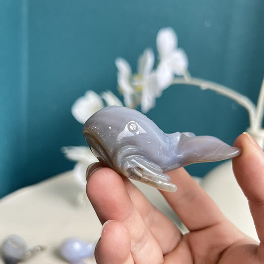 Natural agate crystal dolphin carving with healing properties and unique patterns