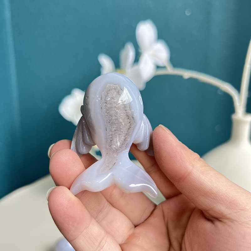 Dolphin crystal carving displayed in home decor arrangement