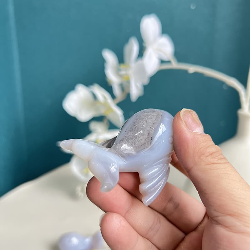 Detailed craftsmanship of tail section on agate crystal dolphin carving