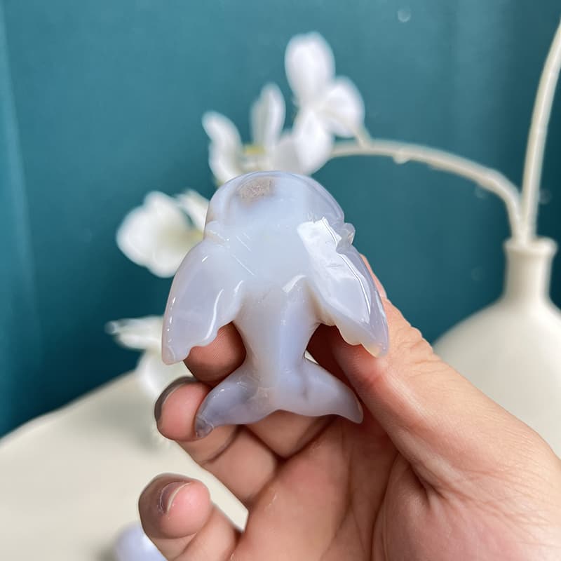  White agate dolphin carving illuminated by natural light showing translucency