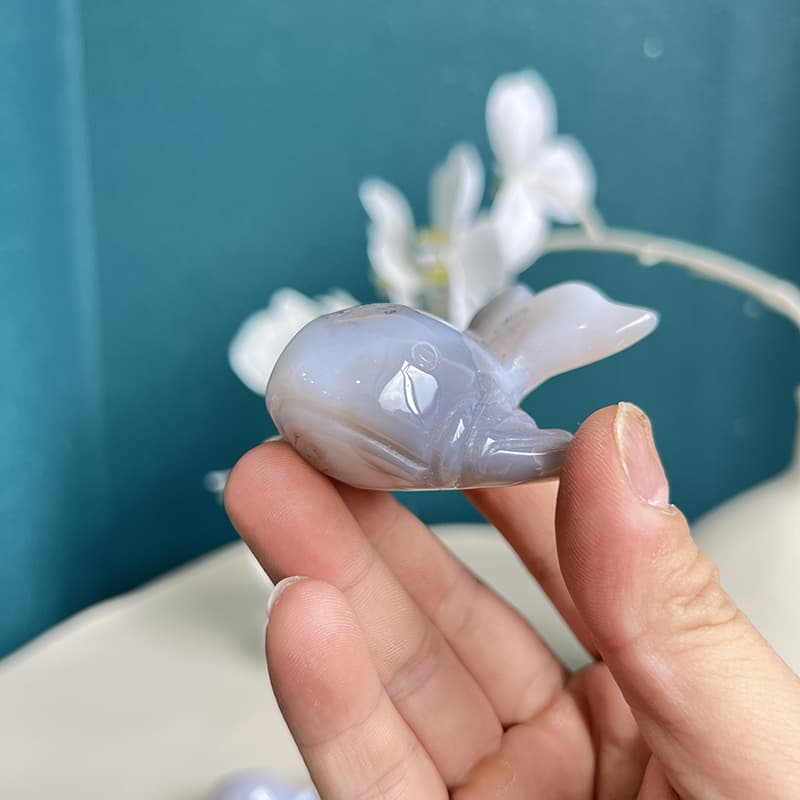  Side profile of handcrafted dolphin crystal carving showing agate patterns