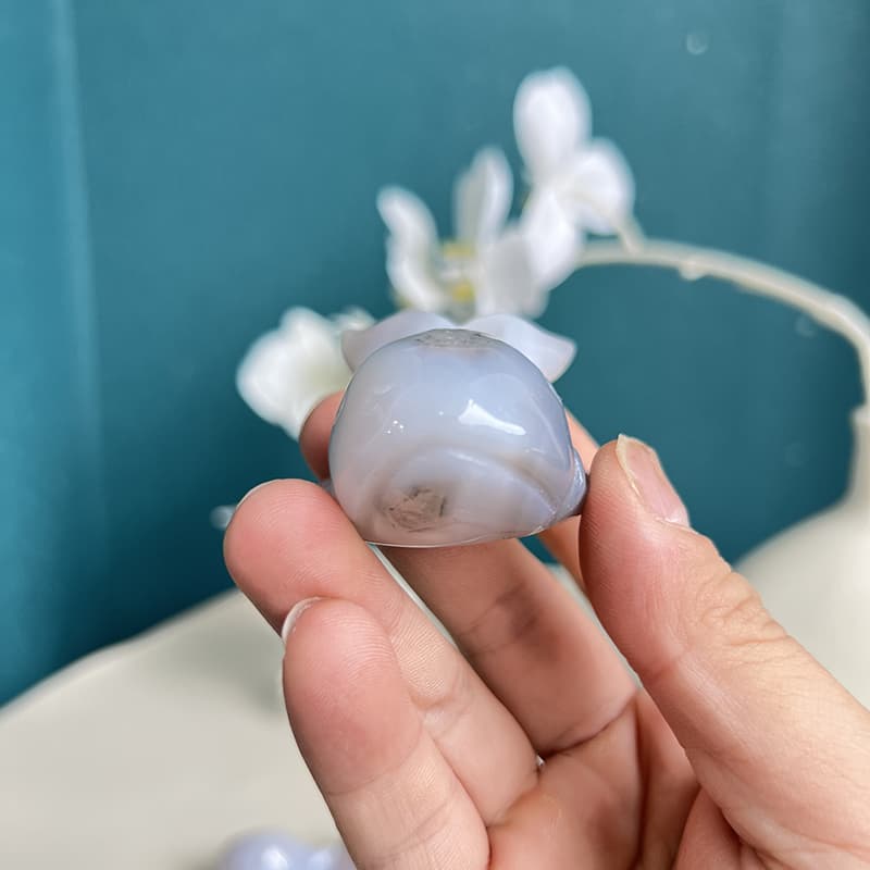 Top view of white agate dolphin crystal figurine displaying translucent qualities