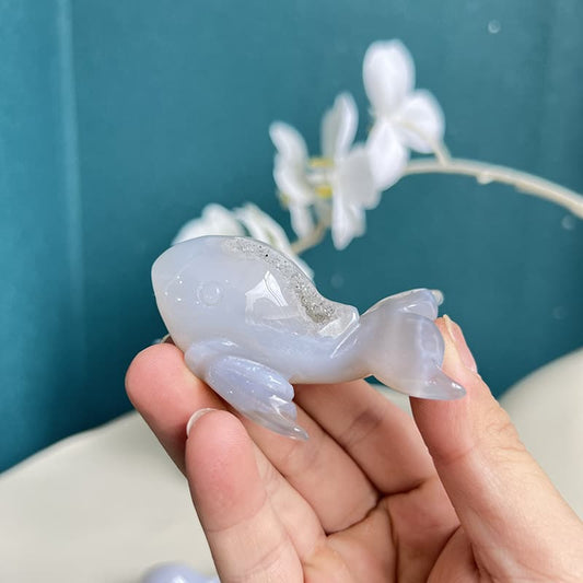 Polished dolphin agate crystal carving with translucent white patterns