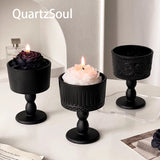 Elegant matte black crystal display stand with decorative pattern design for candles and crystals