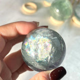 Various sizes of light green fluorite crystal spheres