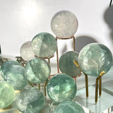 Light green fluorite sphere in meditation space arrangement