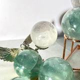 Natural banding patterns in light green fluorite crystal sphere