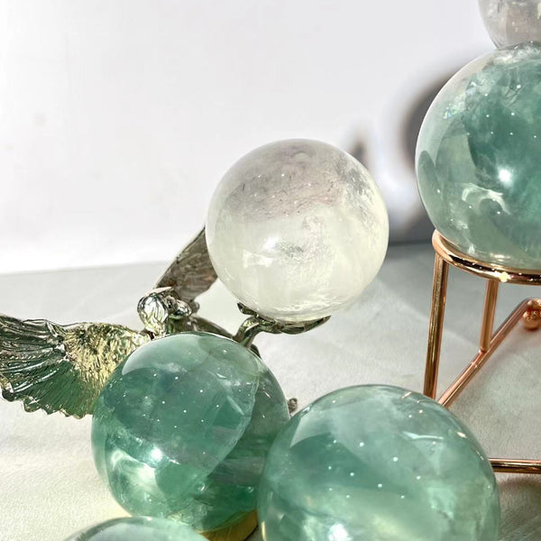 Natural banding patterns in light green fluorite crystal sphere