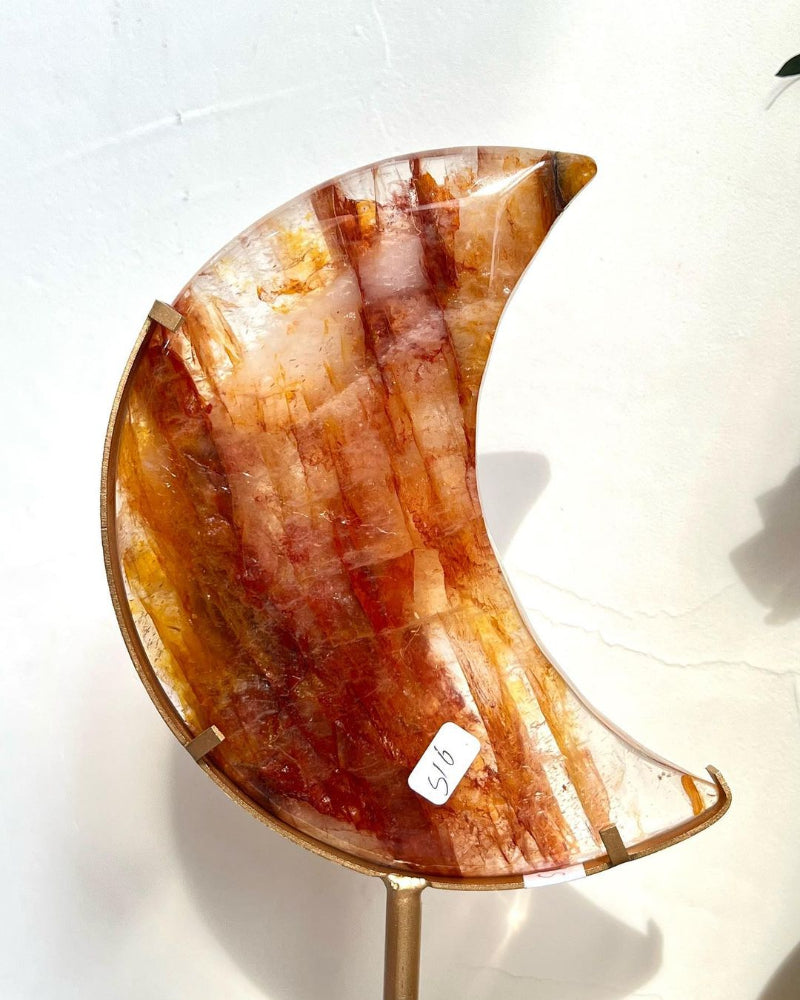 Golden Healer Moon Crystal used in meditation setting with soft lighting