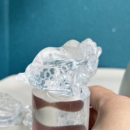 Detailed craftsmanship of golden toad crystal carving