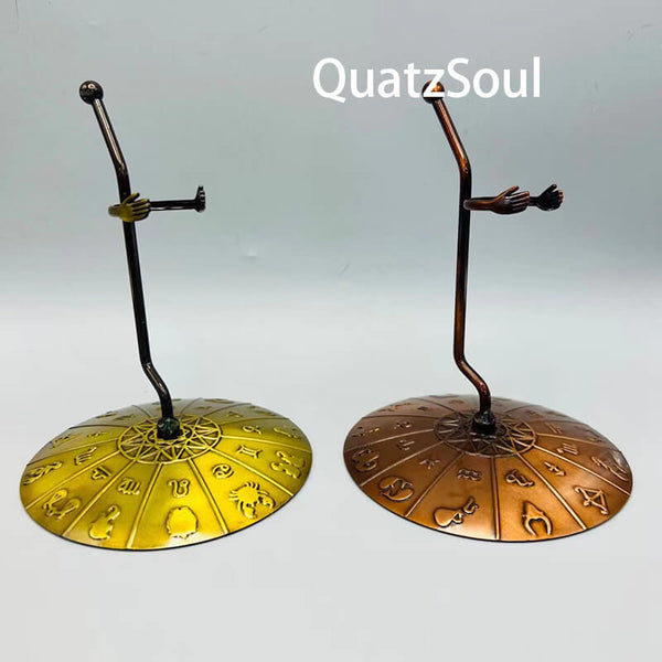 Hand-shaped crystal stand with zodiac base in gold and copper finishes