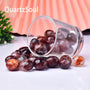 Natural Hematoid Quartz tumbled stones with red inclusions in glass jar