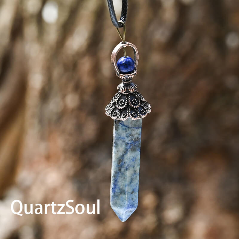 Hexagonal crystal pendulum with ornate metal cap for divination