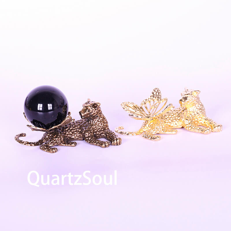 Elegant leopard crystal ball stand with butterfly wings in gold and coppery metallic finish displaying black sphere