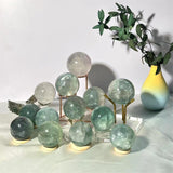 Premium light green fluorite crystal sphere with natural banding pattern