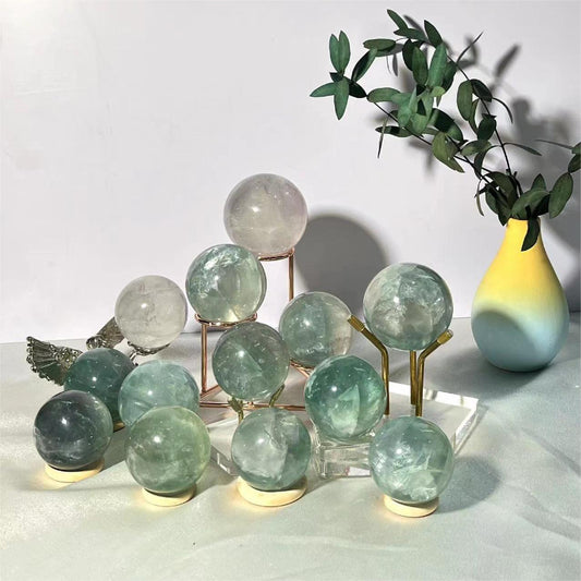 Premium light green fluorite crystal sphere with natural banding pattern