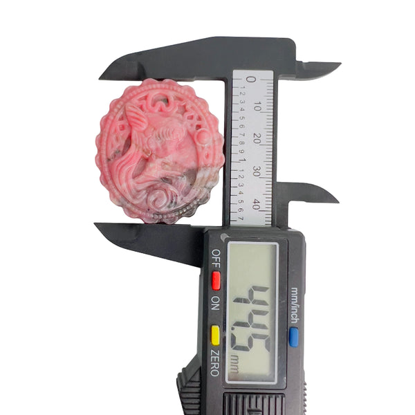 Back view of pink rhodonite crystal carving showing natural patterns