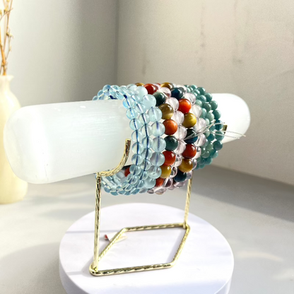 Versatile crystal display stand holding various mineral specimens