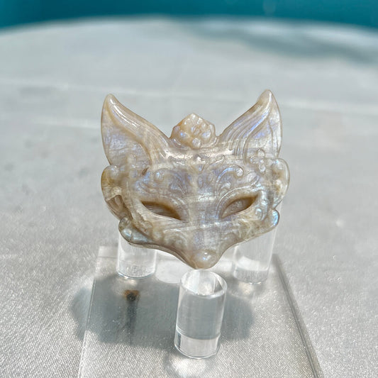 Moonstone fox carving displayed on crystal stand showing shimmer effect