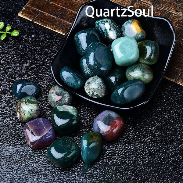 Moss Agate tumbled stones displayed in black dish showcasing earth element healing crystals